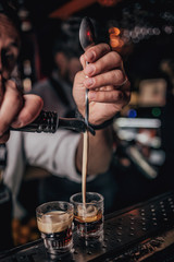 Fototapeta na wymiar bartender pours alcoholic cocktail