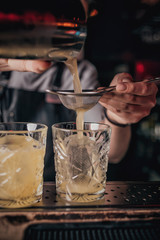 Fototapeta na wymiar bartender pours alcoholic cocktail