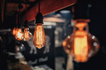 Incandescent lamps in a modern cafe. Edison lamp. Vintage Style.