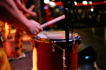 Drummer hands playing drum set at concert on stage. Music show. Bright scene lighting in club,drum...