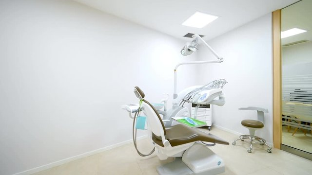 Professional and well equipped dental clinic with a moder seat and tools. Dentist specialist concept. Cinematic camera movement