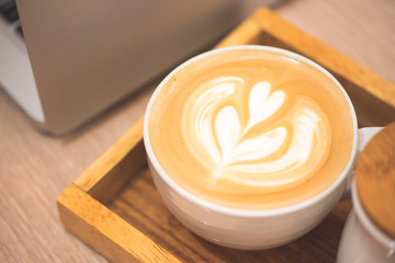 Close up latte coffee on the working table..