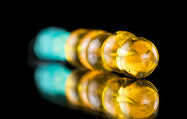 Golden transparent capsules on the needle look like Christmas decorations