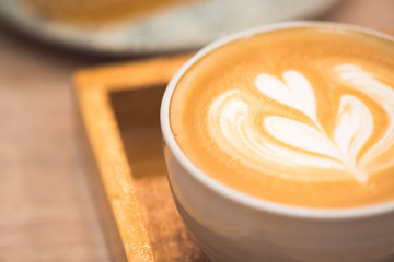Close up latte coffee on the working table..