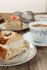 Two cut pieces of Spanish typical dessert of epiphany close-up and coffee