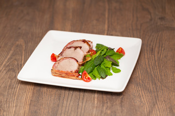 Roasted Pork Tenderloin Wrapped in bacon with lettuce and tomatoes