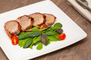 Roasted Pork Tenderloin Wrapped in bacon with lettuce and tomatoes