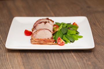 Roasted Pork Tenderloin Wrapped in bacon with lettuce and tomatoes