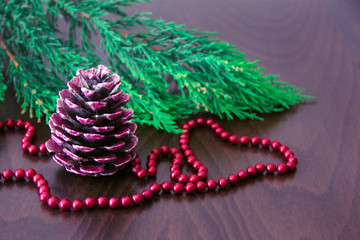 New Year's colorful cones and branches of a green Christmas tree with decor in the form of red beads