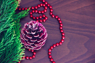 New Year's colorful cones and branches of a green Christmas tree with decor in the form of red beads