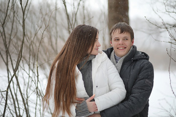Fototapeta premium pair of lovers on a date winter afternoon in a snow blizzard
