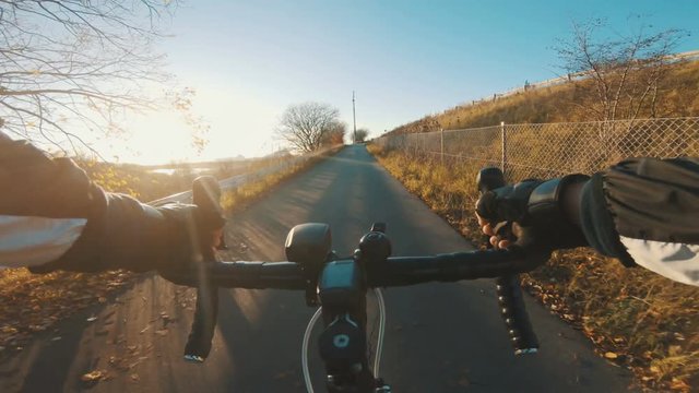 Point Of View Of Riding Racing Bicycle Up Steep Hill While The Sun Sets