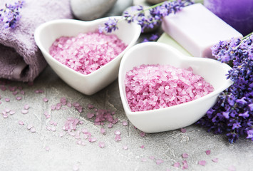 Heart-shaped bowl with sea salt, soap and  lavender flowers