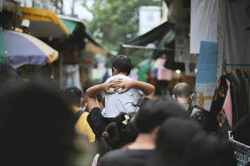 Boy sitting on his father's shoulders