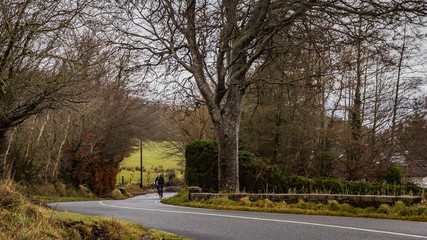 man rides road bicycle uphill