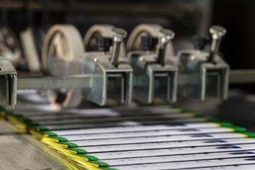 Folding machine industrial. Demonstration of the workflow. Equipment for color printing.