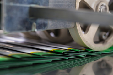 Folding machine industrial. Demonstration of the workflow. Equipment for color printing.