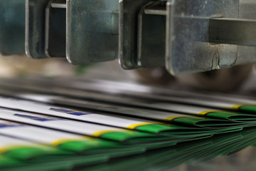 Folding machine industrial. Demonstration of the workflow. Equipment for color printing.