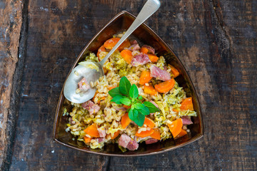 Pearl barley and bacon cassarole with carrots, leek and savoy cabbage - top view