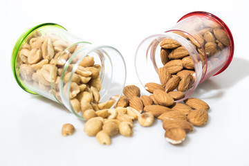Peanuts and almonds in a jar isolated in a white background