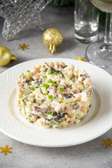 Russian salad with meat, potatoes, egg, cucumber, onion, mushrooms and mayonnaise. Olivier for new year table, Christmas snack