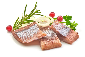 Atlantic salted herring fillet with onion ring and herbs, isolated on a white background. Close-up