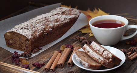 Homemade banana bread with anis star and cinnamon on a dark wooden background