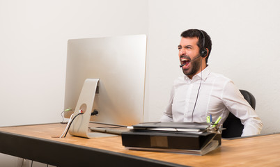 Telemarketer man in a office shouting to the front with mouth wide open