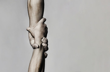 Helping hand concept and international day of peace, support. Helping hand outstretched, isolated arm, salvation. Close up help hand. Two hands, helping arm of a friend, teamwork. Black and white - obrazy, fototapety, plakaty