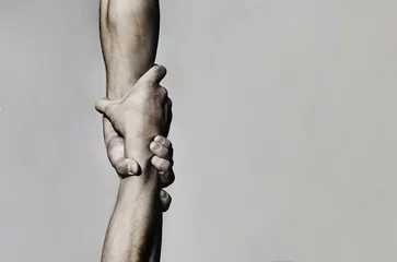 Fotobehang Helping hand concept and international day of peace, support. Helping hand outstretched, isolated arm, salvation. Close up help hand. Two hands, helping arm of a friend, teamwork. Black and white © Yevhen