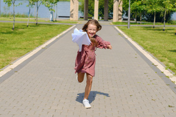 joyful child running with an umbrella