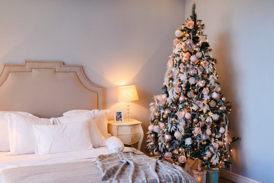 Interior Of Cozy Room Decorated In Christmas Happy New Year Style. No People. An Empty Sofa, Christmas Tree With Presents Under It. Selective Focus. Happy NY Mood