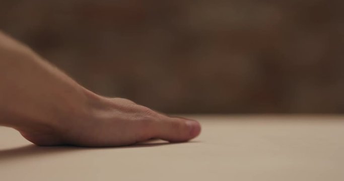 Closeup man hand touches plywood to check surface