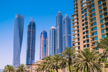 Dubai skyline with skyscrapers on a sunny day. Construction concept.