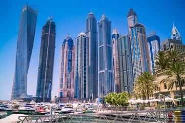 Fototapeta na wymiar Dubai skyline with skyscrapers at the marina on a sunny day. Construction concept.