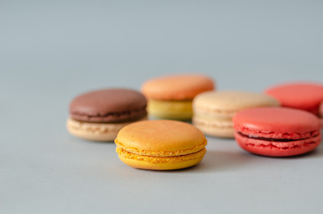 Colorful macaroons are on the light gray background,