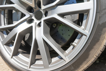 Super car disc brake. Car wheels. steel alloy car disks background template for design work. Car alloy wheel. Close-up shot of a car's brake disc.