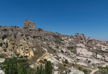 Fototapeta na wymiar Uçhisar, Turkey - A Unesco World Heritage site, Cappadocia is famous for its fairy chimneys, churches and castles carved in the rock, and a unique heritage