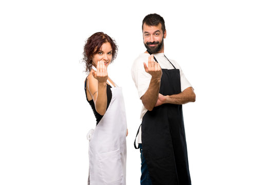 Couple of cooks presenting and inviting to come with hand on isolated white background