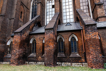 Dark brick wall of an old Catholic cathedral.
