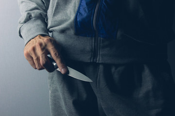 gangster threatens with a knife