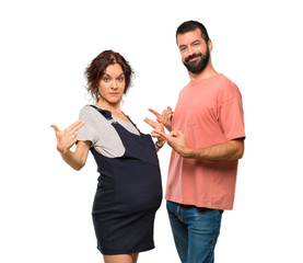 Couple with pregnant woman proud and self-satisfied in love yourself concept on isolated white background