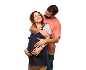 Couple with pregnant woman hugging on isolated white background