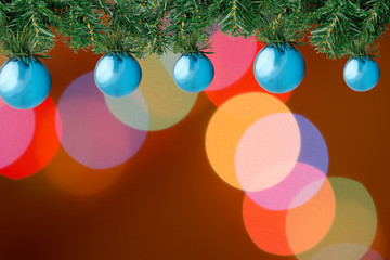 Christmas frame fir tree with decoration blue balls on bokeh lights out of focus background with copy space