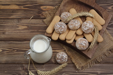 Gingerbread and cookies with milk on a wooden table
