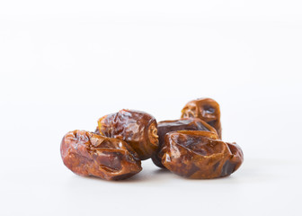 Dried halawi dates on a white