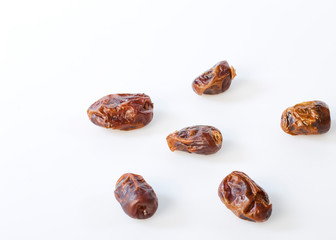 Dried halawi dates on a white