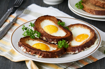 Baked toasts with egg filling and fresh parsley on a plate    