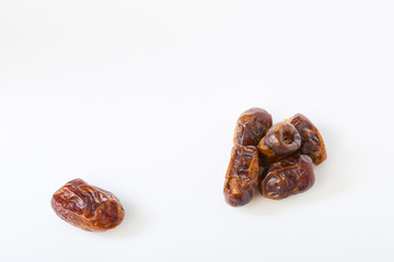 Dried halawi dates on a white