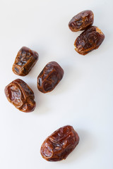 Dried halawi dates on a white